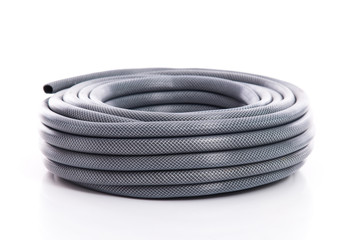 curled garden hose isolated on white