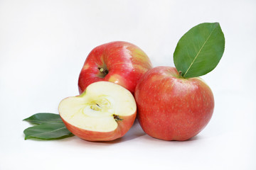 Red ripe apples and apple slice on a white background.