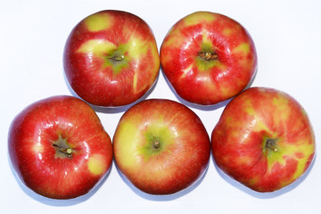 Apples on white surface, top view.