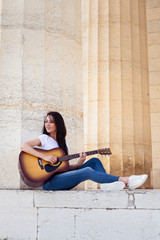 Fototapeta na wymiar Beautiful smiling Woman playing acoustic Guitar