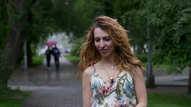 portrait of young beautiful woman in rain. slow motion