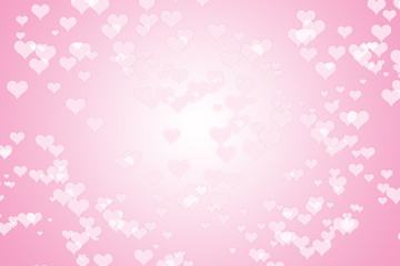 A pink hearts background in a bokeh style effect for Valentine's Day. Bokeh background image of white heart on pink.