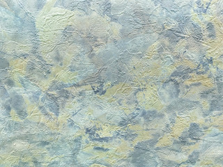 Structure of abstract background in the form of a rough patchy plaster of light blue color. Texture of colorful decorative wallpaper, closeup.