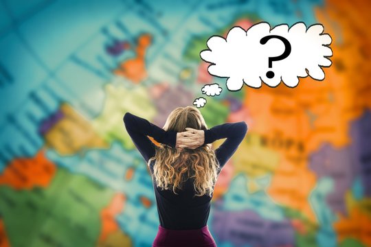 woman thinking ahead of the world map