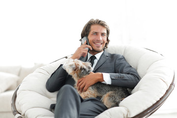 business man talking on the phone and holding his pet