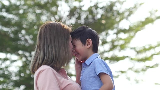 Asian mother and her son playing in the park,slow motion2