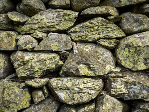 Dry Stone Wall. Traditional lichen covered stone wall as is typically found in rural British farming areas. Full frame abstract background texture.