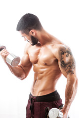 Male fitness model posing shirtless with weights