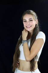 Naklejka premium happy teenager with long hair in white shirt smiling