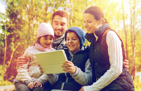 happy family with tablet pc at camp