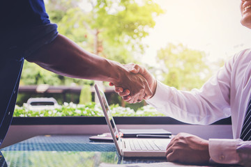 two businessman hand shake while business meeting in office