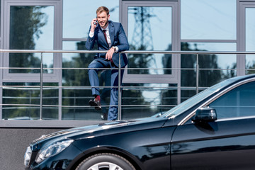 businessman at office building and car