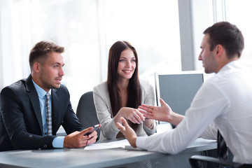 Business team conducts an interview with a young candidate.