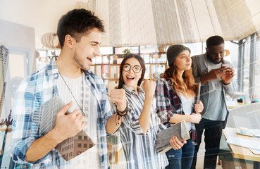 Positive colleagues feeling happy after victory