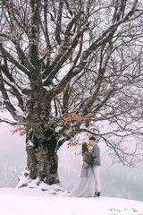 Young pretty pair of lovers. Winter. Date. A pair of lovers on a date in the mountains.