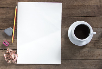 drawing pencil on white paper sheet with wooden texture background. coffee cup