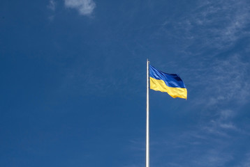 Ukrainian national flag on the blue sky background
