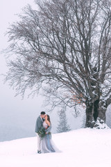 Young pretty pair of lovers. Winter. Date. A pair of lovers on a date in the mountains.