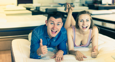 Man and woman choosing mattress