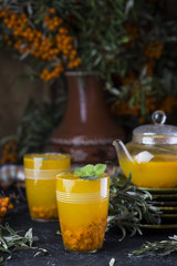 tea with sea-buckthorn on a black background
