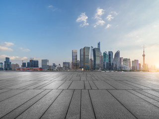 Obraz premium cityscape and skyline of shanghai from empty brick floor.