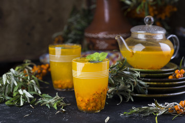 tea with sea-buckthorn on a black background