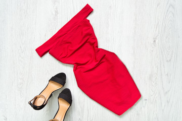 Red dress with downcast shoulders, black shoes. Fashionable concept.