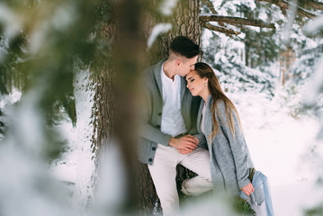 Young pretty pair of lovers. Winter. Date. A pair of lovers on a date in the mountains.