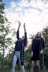 Mother and daughter catching hat