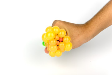 The hand is squeezing the rubber ball.