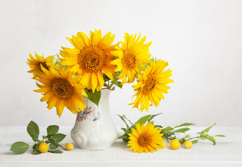 Still life with bouquet of sunflowers, and cherry plums.