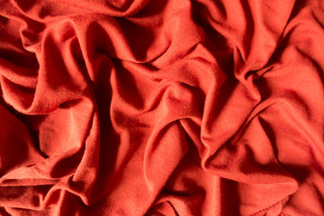 Orange cotton jersey fabric in soft folds