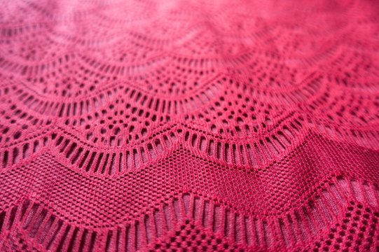 Sophisticated pattern on ruby red lacy fabric