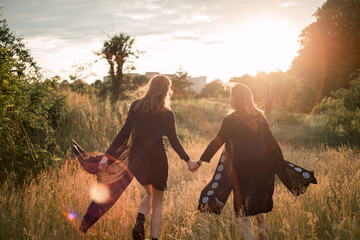 Mother and daughter photographed holding hands