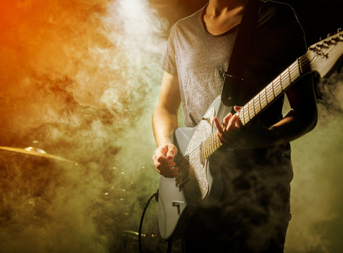 Guitarist plays solo.