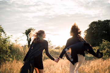 Mother and daughter photographed holding hands