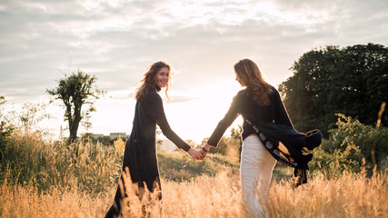 Mother and daughter photographed holding hands