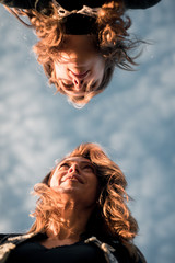 women photographed against blue sky