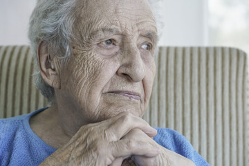 closeup of a thoughtful senior woman at home