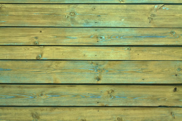 Ancient vintage wooden texture. Painted yellow, wall. Cracked paint. Grunge colored background for design. Stock Photo