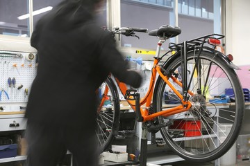 Mechanic while repairing the bicycle inside the mechanical works