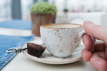 An empty cup of coffee on a wooden table.
