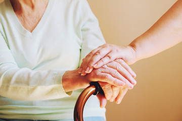 Senior woman with her caregiver at home. Concept senior people health care.