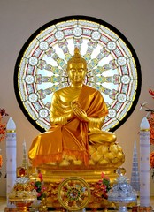 Golden buddha statue with Dharma wheel at Wat Phasornkaew, A famous buddhist temple, Phetchabun, Thailand,