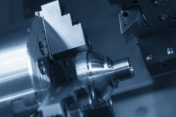 CNC lathe machine or Turning machine chucking the steel cone shape rod .Hi technology manufacturing process.