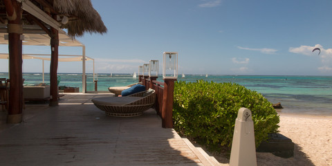 background of beach and sunbeds and empty wooden summer terrace
