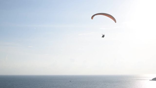Paragliding flying in the blue sky,Phuket,Thailand.