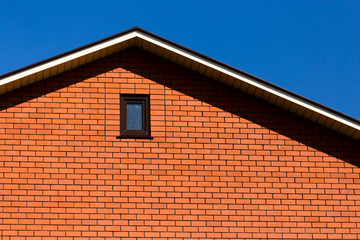 roof with a window in a brick house