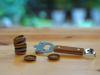 Bottle Opener with a cap on a wooden table. Natural Light.