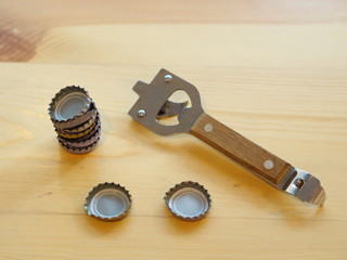 Bottle Opener with a cap on a wooden table. Natural Light.
